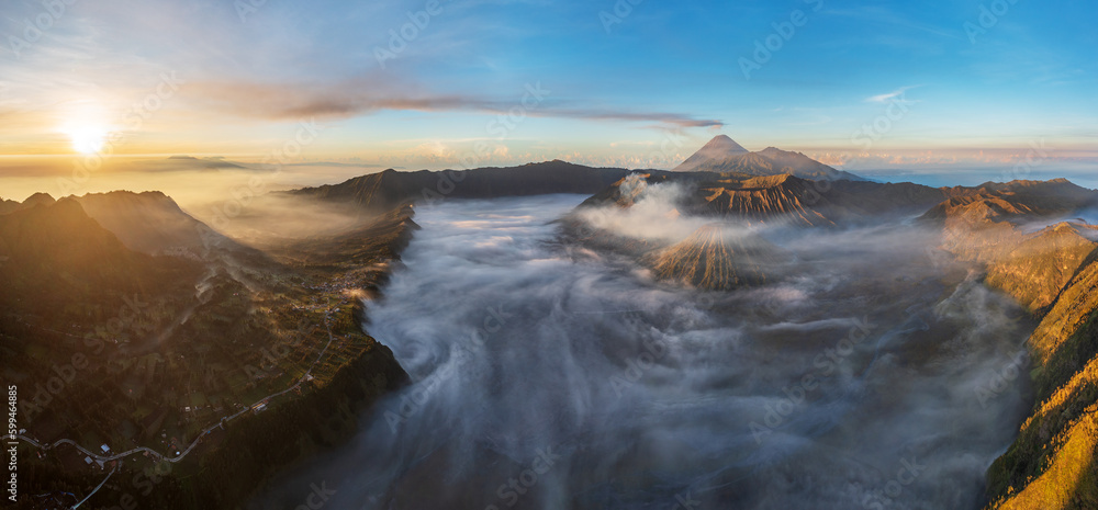 Panoramic view of Mount Bromo and Cemoro Lawang village, Bromo Tengger Semeru national park, Java, Indonesia 2023.  Nature landscape background. Southeast Asia