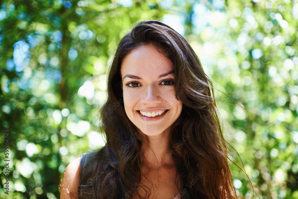 The perfect day to be out in nature. Portrait of a beautiful young woman standing in a forest. The perfect day to be out in nature. Portrait of a beautiful young woman standing in a forest.