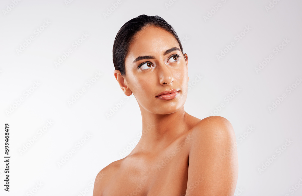 Shes magic, that one. Studio shot of a beautiful young woman posing against a gray background. Shes magic, that one. Studio shot of a beautiful young woman posing against a gray background.