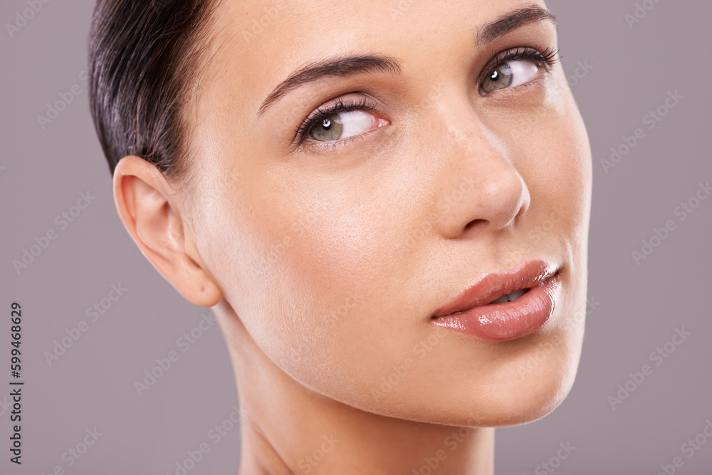 Fototapeta premium Seeing her beauty close up. Beauty shot of a beautiful young woman with perfect skin against a gray background.