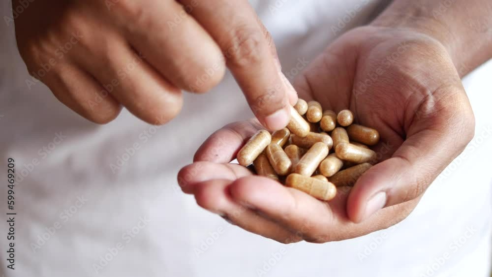 men hand pick herbal medicine capsule men hand pick herbal medicine capsule
