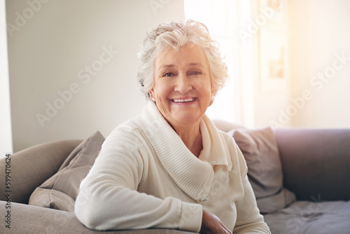 Relax, happy and portrait of old woman on sofa for free time, retirement and weekend. Smile, happiness and mindset with senior person in living room at home for elderly, positive and carefree photo