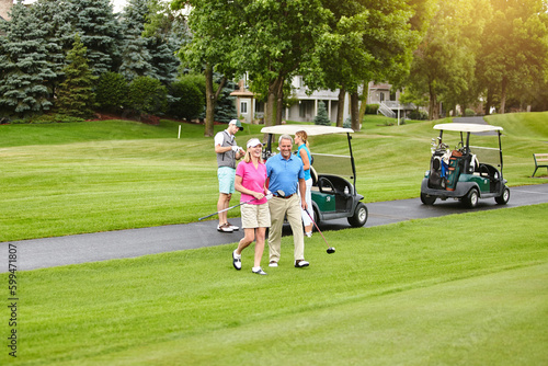 Youll find us on the golf course. a mature couple out playing golf together.