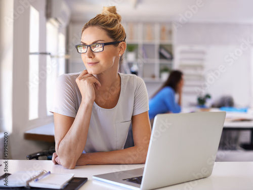 Thinking, fashion and designer with woman and laptop for creative, planning and retail. Boutique, small business and internet with female employee in workshop for store, industry and tailor