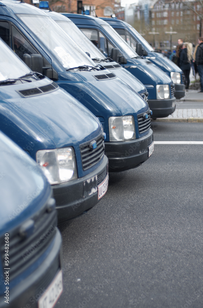 Security, police and row of vans in the city for a public service during a protest or march. Safety, crime and law enforcement transport in a line as a barrier in an urban town strike for protection.