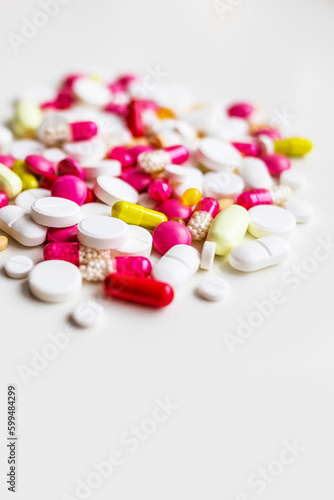 Pile of colorful medicine pills, vitamins on white background. top view.selective focus. Tablets pharmacy concept.drugs pills heap.Medication treatment, pharmacy and medicine.copy space