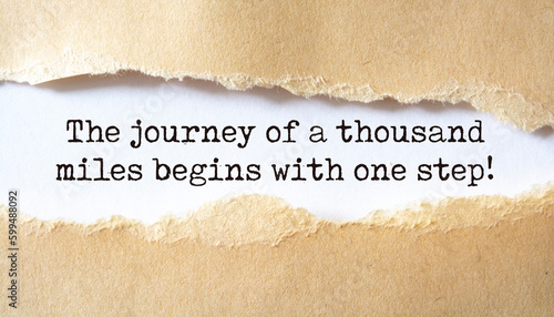Inspirational motivational quote. The journey of a thousand miles begins with one step. photo