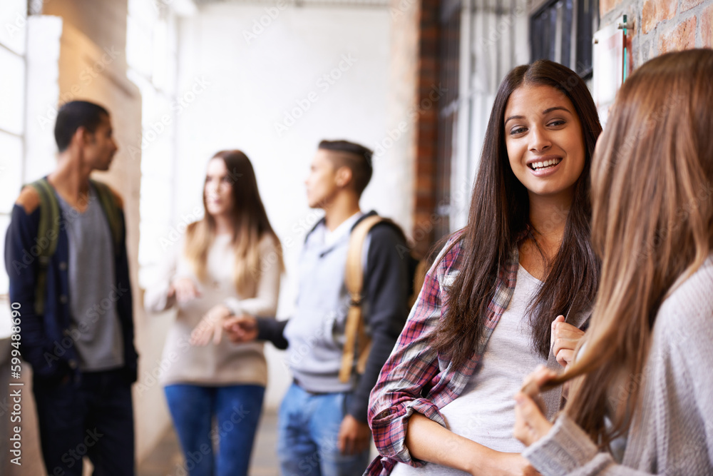 Girl friends, university and hallway people talking with happiness, bonding or discussion together. Teenager, college or school communication of young gen z students on campus for education and class Girl friends, university and hallway people talking with happiness, bonding or discussion together. Teenager, college or school communication of young gen z students on campus for education and class