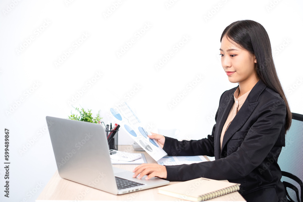 Smart business woman is sitting at workplace and planing about marketing investment from the graph. Smart business woman is sitting at workplace and planing about marketing investment from the graph.