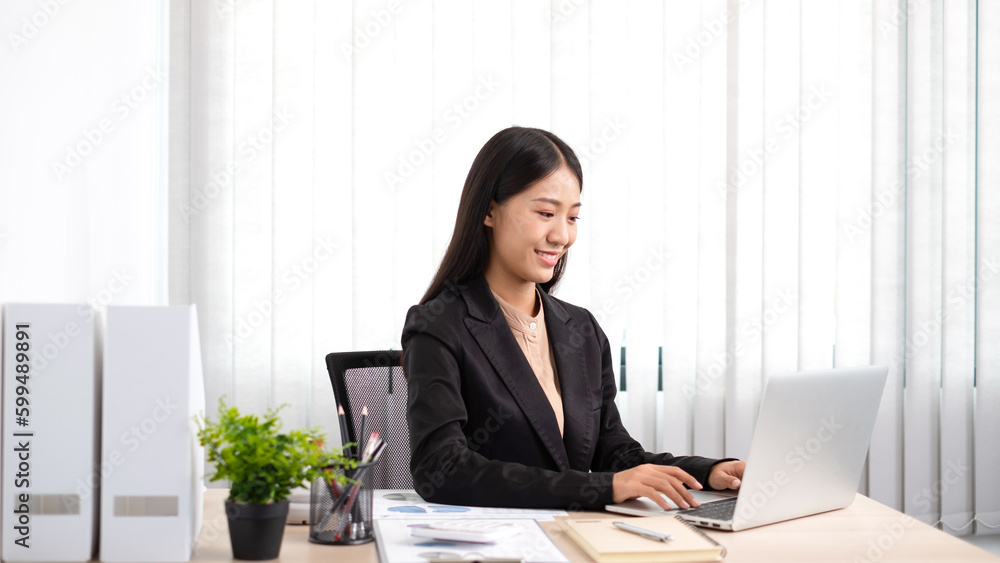 Smart business woman is sitting at workplace and using computer. Smart business woman is sitting at workplace and using computer.