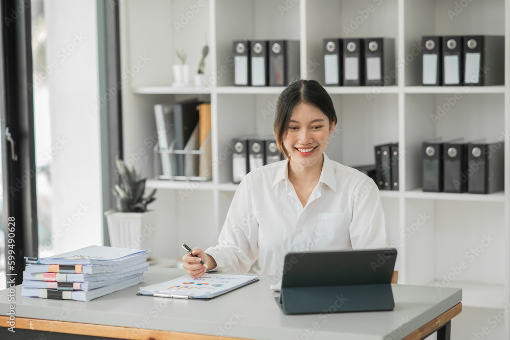 Asian businesswoman sitting and working about documents at the office Asian businesswoman sitting and working about documents at the office