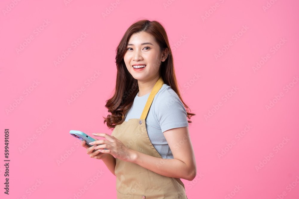 portrait of asian girl wearing apron on pink background portrait of asian girl wearing apron on pink background