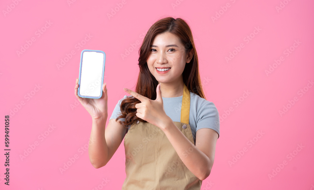 portrait of asian girl wearing apron on pink background portrait of asian girl wearing apron on pink background