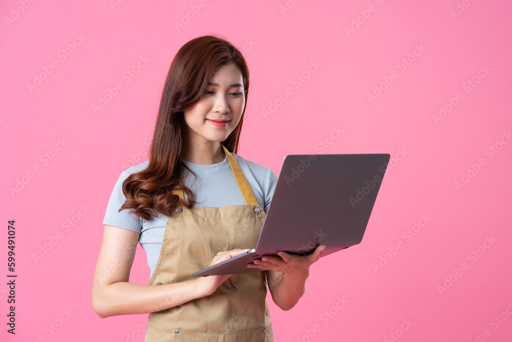 portrait of asian girl wearing apron on pink background portrait of asian girl wearing apron on pink background