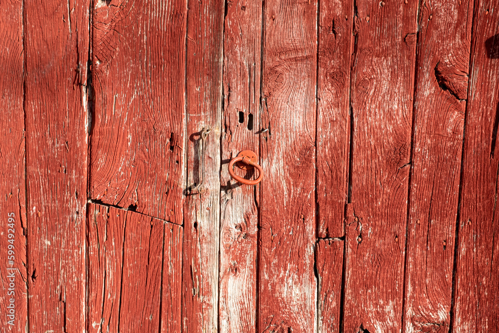 detail of the texture of an old wooden door painted red detail of the texture of an old wooden door painted red