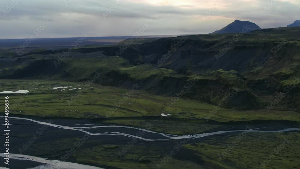 Aerial drone cinematic downward movement of Solheimajokull glacier Iceland rivers flowing to the sea late afternoon Aerial drone cinematic downward movement of Solheimajokull glacier Iceland rivers flowing to the sea late afternoon