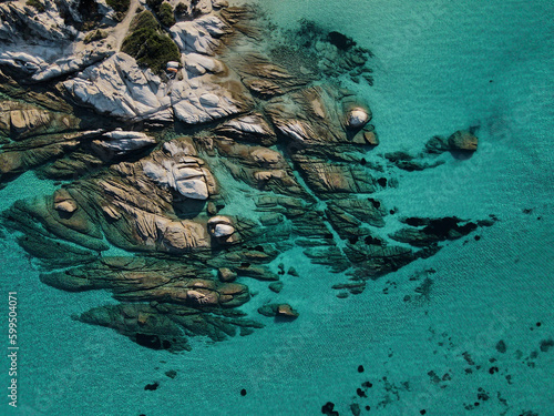 Drone photo top down view of rock formation and clear blue water at kavourotrypes beach Greece photo