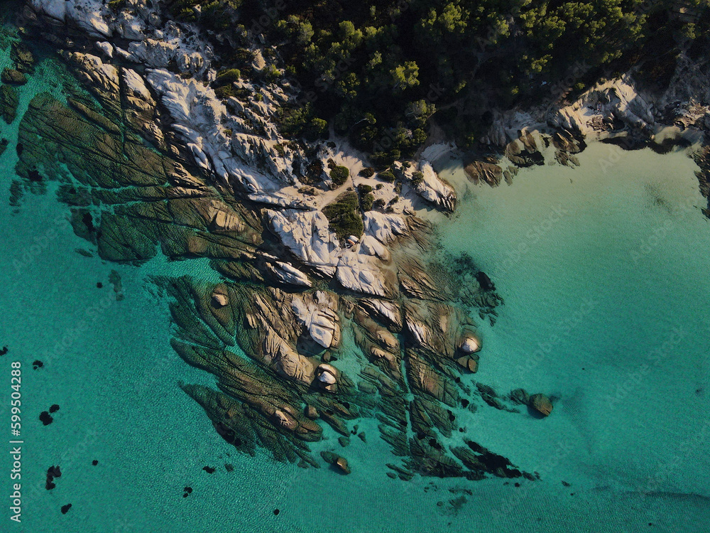 Naklejka premium Drone photo top down view of rock formation and clear blue water at kavourotrypes beach summer Greece