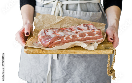 The chef holds pork ribs on a wooden cutting Board.  Isolated, transparent background