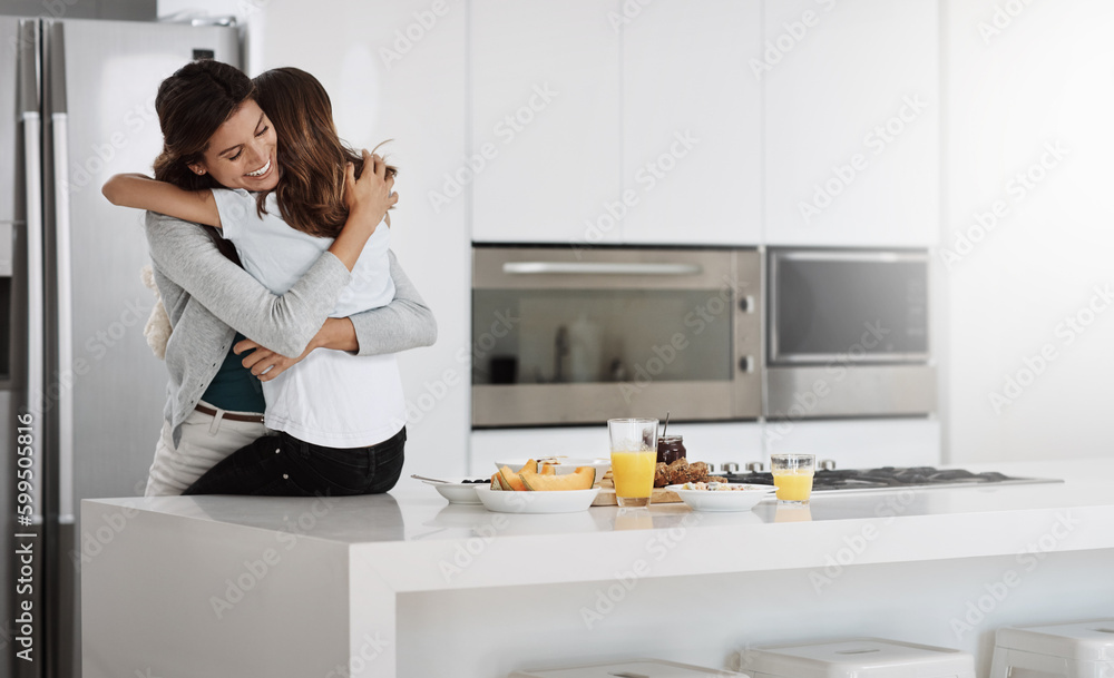 Their love is special. an attractive young woman and her daughter hugging while spending time together at home. Their love is special. an attractive young woman and her daughter hugging while spending time together at home.