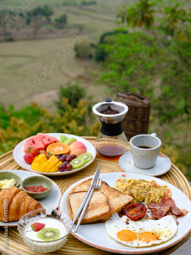 American breakfast with eggs, bread,bacon,milk, coffee and orange juice