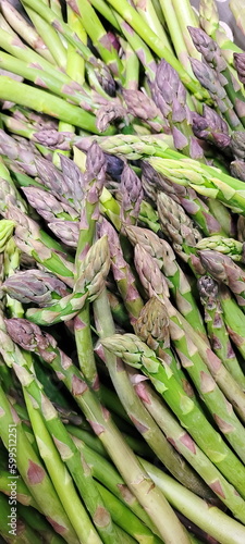 Green asparagus pods, carefully picked from the garden, are waiting to be cooked as a side dish or main course.