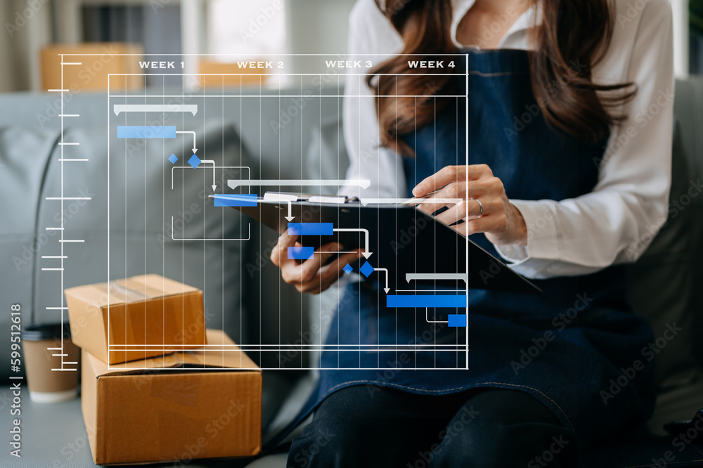 Fototapeta premium Woman hand using a laptop, smartphone and tablet and writing notebook at the office of her business online shopping. In home