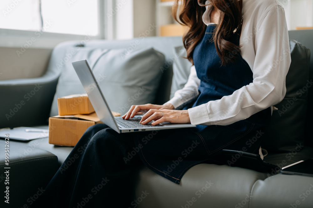 Woman hand using a laptop, smartphone and tablet and writing notebook at the office of her business online shopping. In home Woman hand using a laptop, smartphone and tablet and writing notebook at the office of her business online shopping. In home