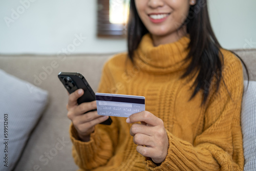 Happy smart young woman Asian using smartphone for shopping, mobile shopping, beautiful woman doing online purchases, shopping online