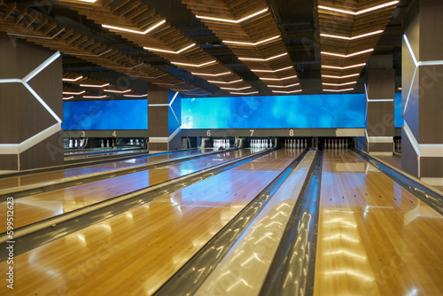 interior of a empty bowling alley. modern interior of bright and colorful bowling club. nobody. Reflection of the lights.