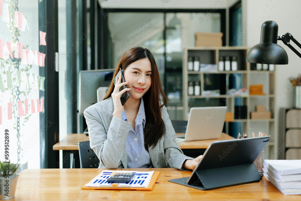 Happy asian business woman have the joy of talking on the smartphone, tablet and laptopon the modern office Happy asian business woman have the joy of talking on the smartphone, tablet and laptopon the modern office