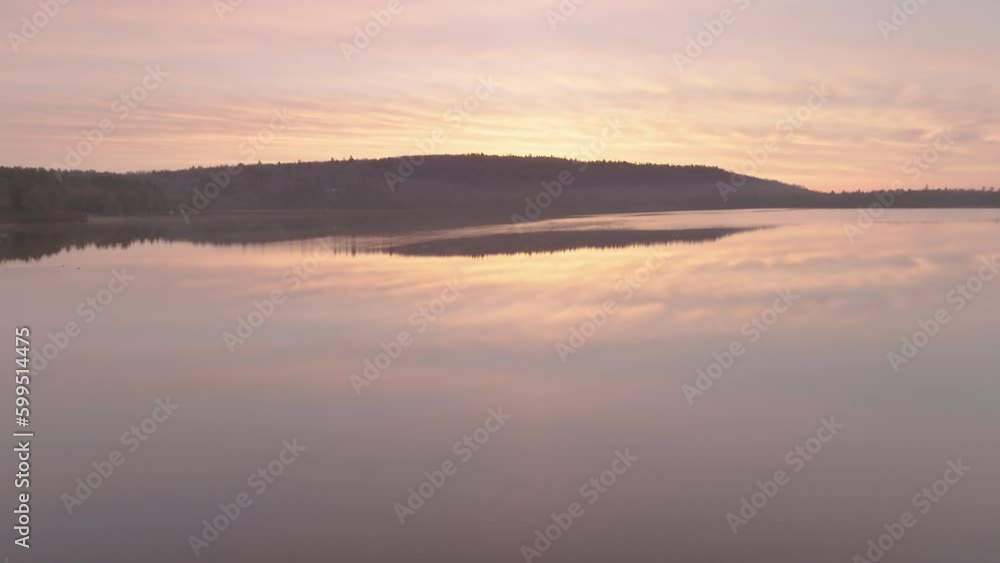 Sunrise over Monson Pond on a flat calm morning Sunrise over Monson Pond on a flat calm morning