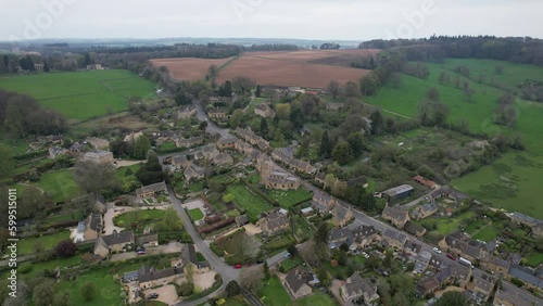 Bourton on the Hill Cotswold village UK high angle panning drone aerial view photo