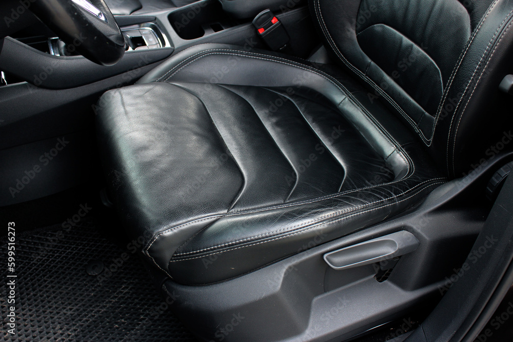 Modern luxury car black leather with alcantara interior. Part of black leather car seat. Interior of prestige car. Leather seats isolated.