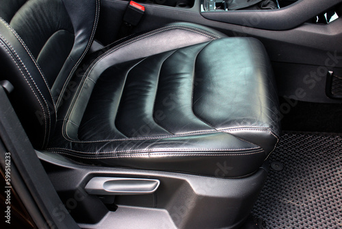 Modern luxury car black leather with alcantara interior. Part of black leather car seat. Interior of prestige car. Leather seats isolated.