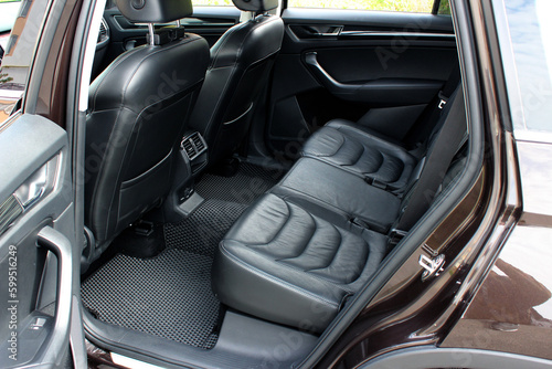 Close-up of the rear seats. Clean after washing the rear passenger seats of matte black genuine leather inside the interior of an expensive luxury suv. Preparation before selling the car.