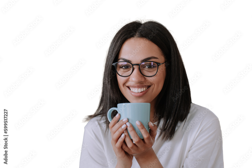 Adorable african american female in glasses and white t-shirt holding cup of coffee, sits against transparent background on sofa looks at camera, broad smiling. Brazilian young woman enjoys holidays. Adorable african american female in glasses and white t-shirt holding cup of coffee, sits against transparent background on sofa looks at camera, broad smiling. Brazilian young woman enjoys holidays.