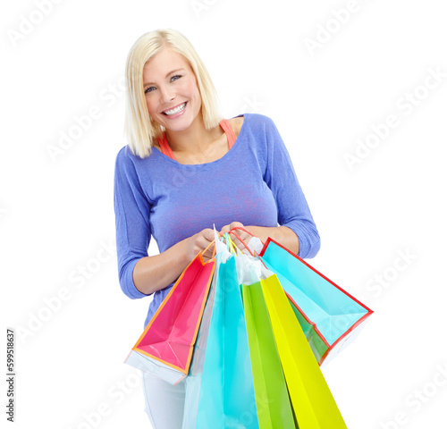 An assortment of awesome clothes. An excited young woman holding shopping bags while isolated on a white background.