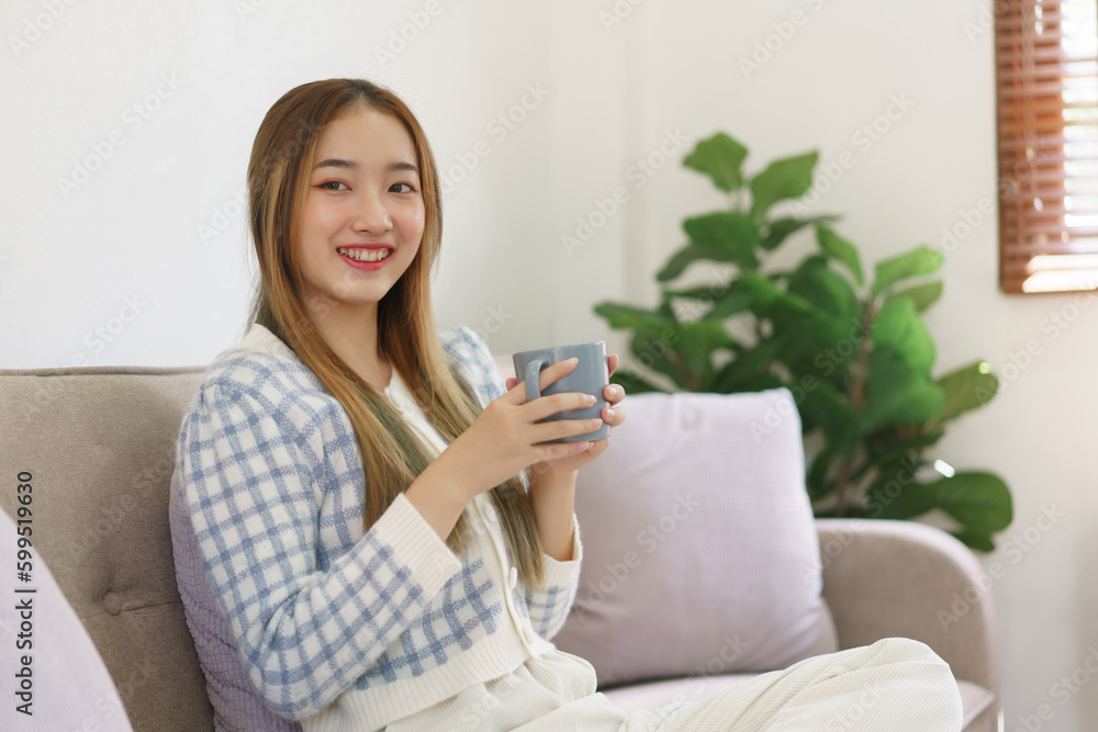 Leisure time concept, Women holding coffee cup and sitting on the couch to spending relax time Leisure time concept, Women holding coffee cup and sitting on the couch to spending relax time