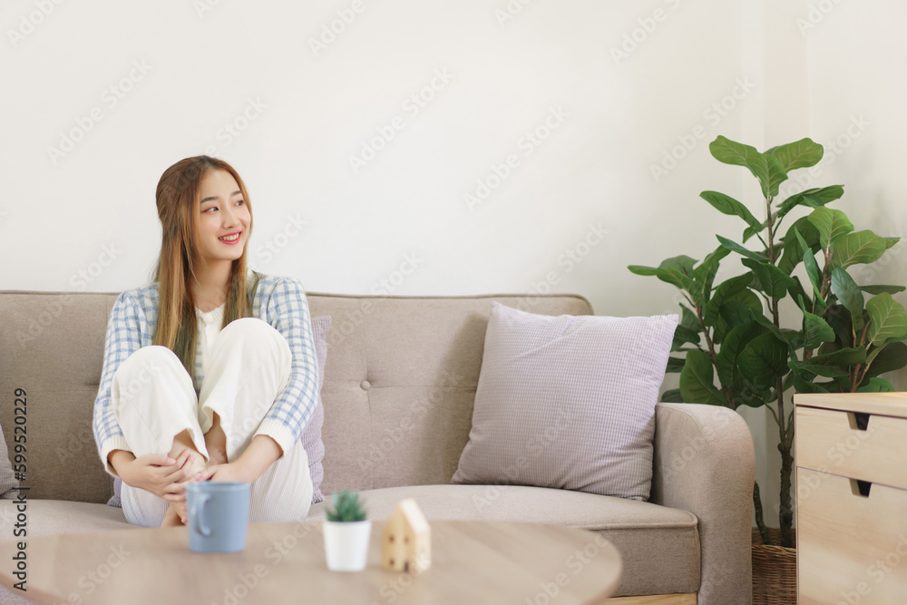 Leisure time concept, Women are sitting on comfort couch and looking outside to thinking something