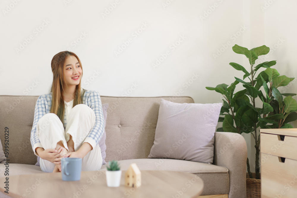 Leisure time concept, Women are sitting on comfort couch and looking outside to thinking something Leisure time concept, Women are sitting on comfort couch and looking outside to thinking something
