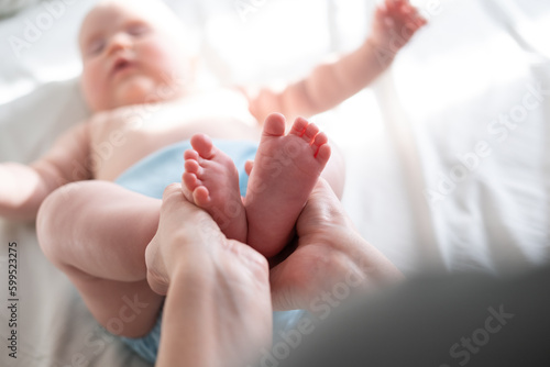 Little baby feet in mother's hands 