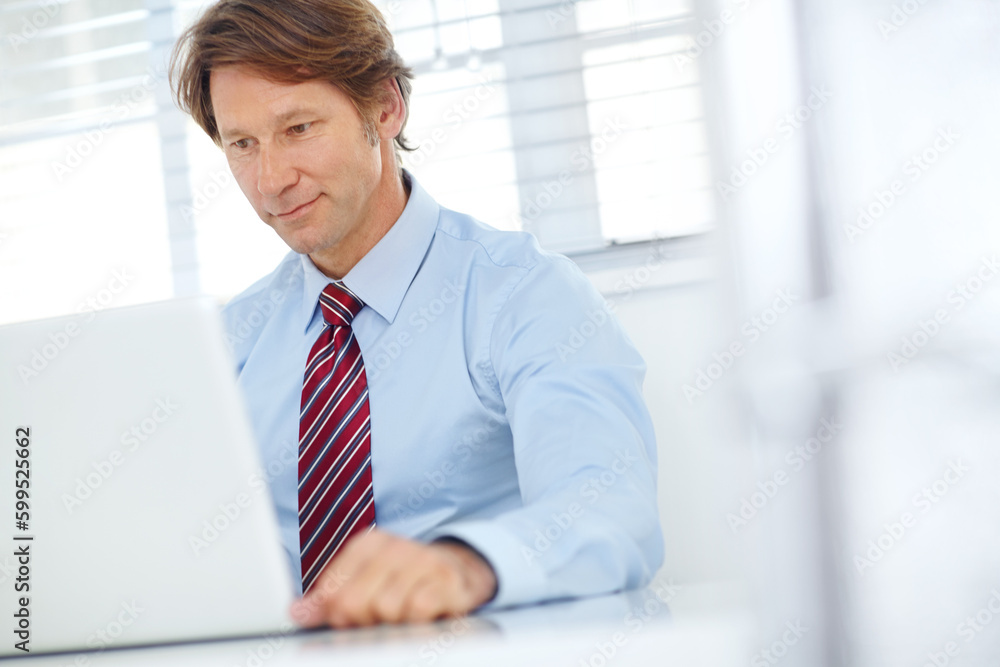 His desk is like a second home. a mature businessman thinking while sitting in front of his laptop. His desk is like a second home. a mature businessman thinking while sitting in front of his laptop.