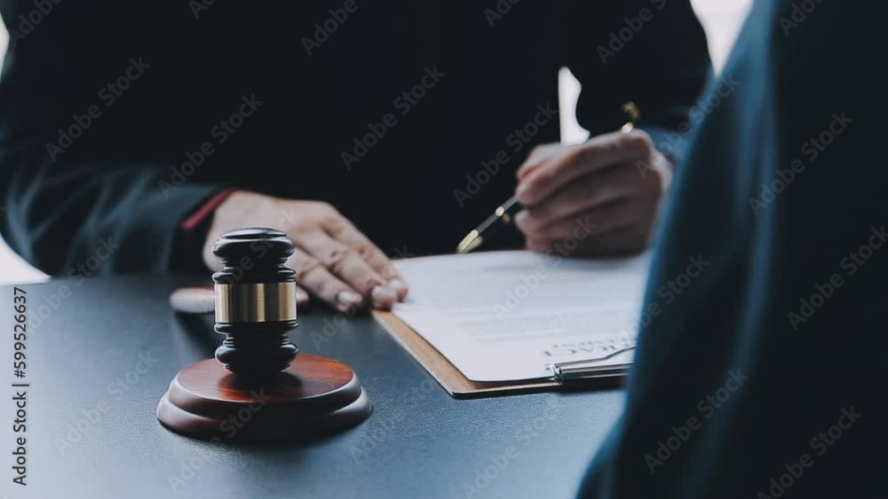 Business and lawyers discussing contract papers with brass scale on desk in office. Law, legal services, advice, justice and law concept picture with film grain effect Business and lawyers discussing contract papers with brass scale on desk in office. Law, legal services, advice, justice and law concept picture with film grain effect