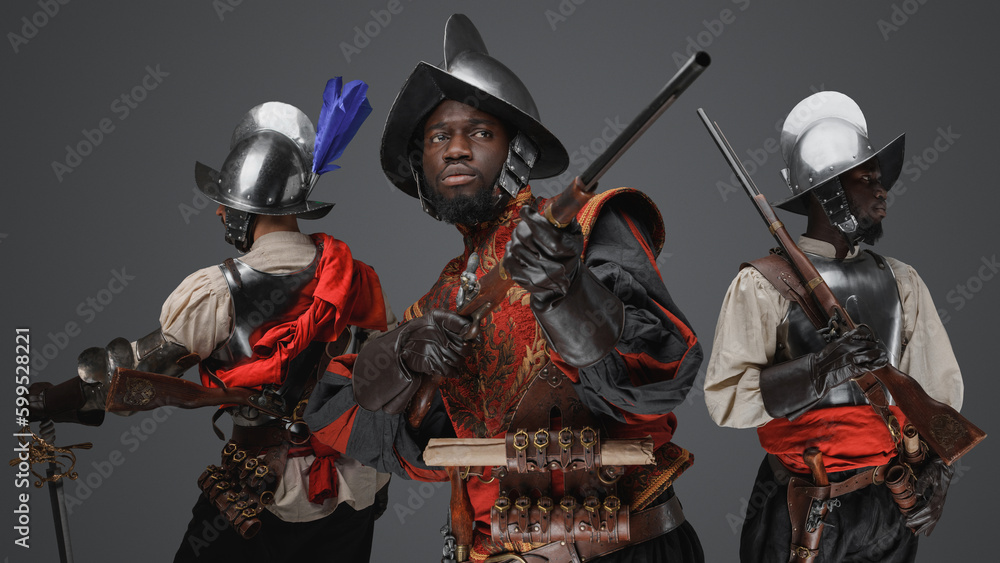 Naklejka premium Portrait of multiethnic group of three conquistadors with steel armors and flintlock rifles.
