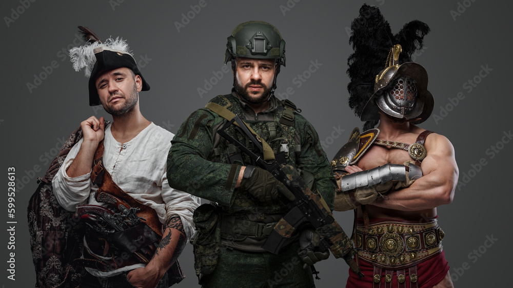Studio shot of modern soldier with camouflage uniform with aribbean pirate and greek gladiator. Studio shot of modern soldier with camouflage uniform with aribbean pirate and greek gladiator.