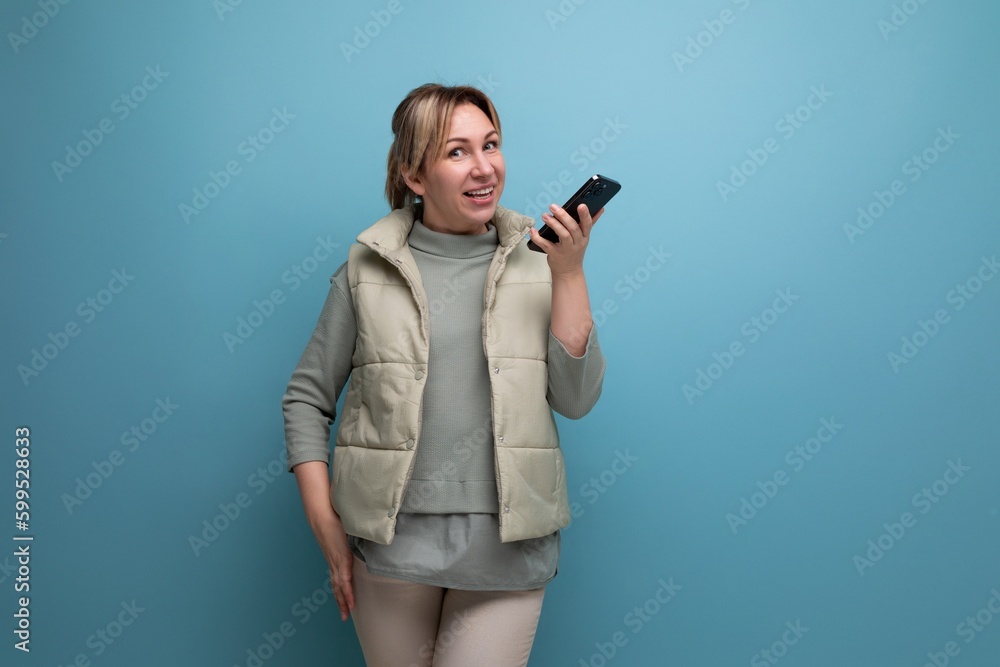 blonde young woman in her thirties talking on the phone blonde young woman in her thirties talking on the phone