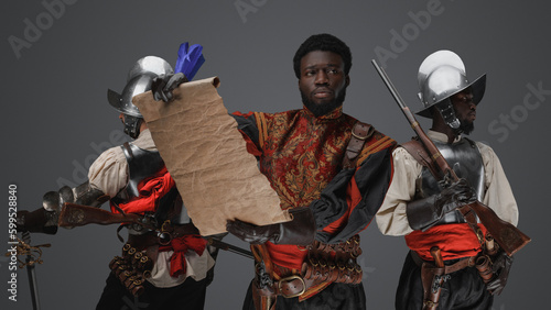 Canvas Print Shot of three conquistadors explorers with map and flintlock guns