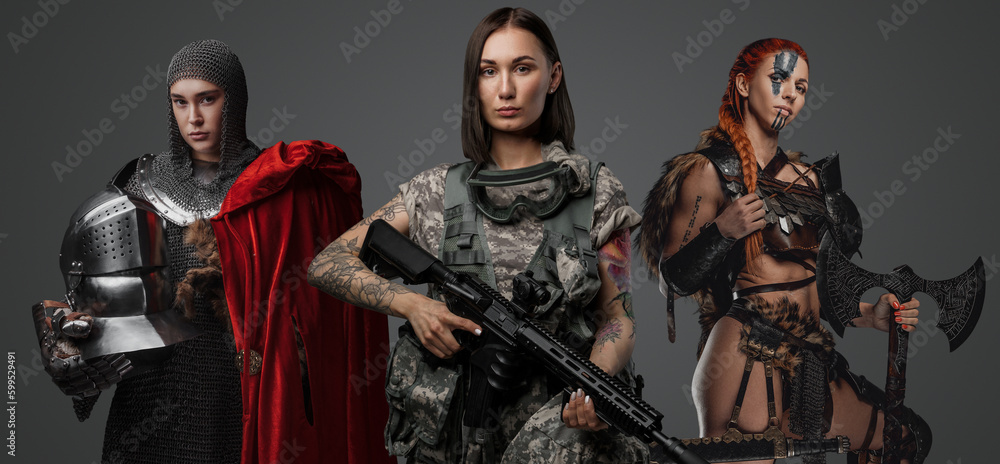 Studio shot of female soldier holding rifle with ancient amazon and knight woman. Studio shot of female soldier holding rifle with ancient amazon and knight woman.