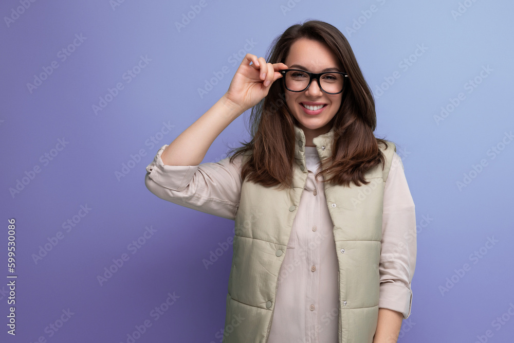 brunette businesswoman in eyeglasses posing on studio background with copy space brunette businesswoman in eyeglasses posing on studio background with copy space